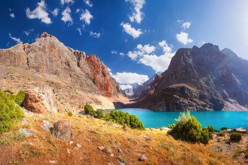 Beautiful mountain landscape in Tajikistan. Fan mountains. Greater Allo lake in Fann mountains. Scenic view on amazing mountain lakes on sunny day