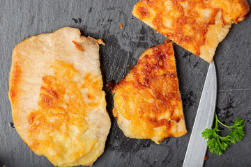 Pork schnitzel on a black slate
