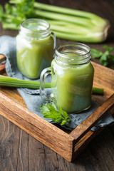 Obraz na płótnie Canvas Freshly made pure celery juice in glass jars