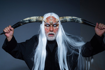 Horror and fantasy concept. Tree spirit and fantasy concept. Monster with white blue eyes. Magic and fairy tale concept. Vampire man with white eyes.