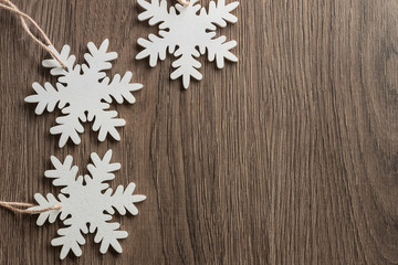Christmas background with white snowflakes, Christmas frame made of wooden toys