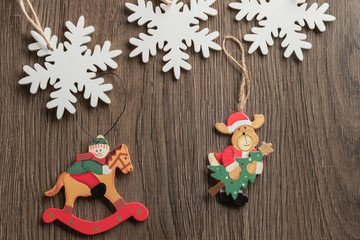 christmas composition with vintage wooden toys, snowflakes, snowman and santa deer
