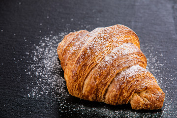 Croissant on black stone