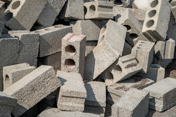 stacks of gray concrete blocks on the ground.
