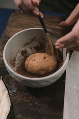 cooking potato cake on a dark wooden background. cooking rum ball.