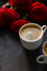 coffee and roses bouquet, flowers (freshly brewed coffee white cup on the table) menu concept. food background. copy space. Top view