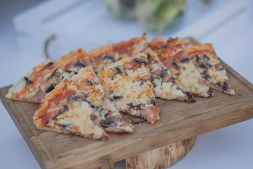 Appetizing diced pizza on a wooden surface