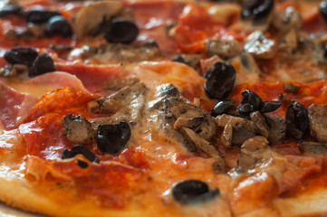 Fresh baked pizza with mushrooms and meat