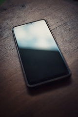Smart phone on a wooden table