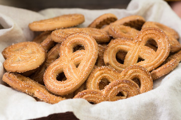 Cookies with sugar in a basket on a wooden table