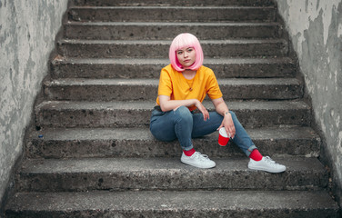 Trendy Asian teenager sitting on steps