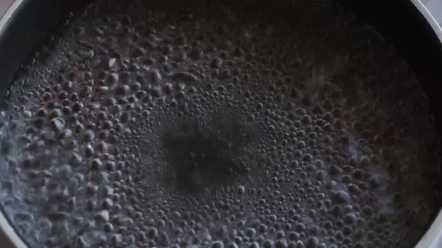 Boiling Water in Black Cooking Pot