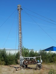 Mobile drilling rig for drilling a water well in working condition.