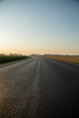 New asphalt road at golden sunset