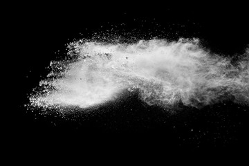 White powder explosion clouds.Freeze motion of white dust particles on black background.