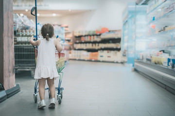 Young girl shopping in supermarket