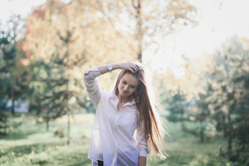 happy girl walks in autumn park at sunset