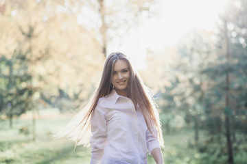 Young beautiful stylish woman walking in autumn park