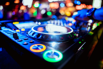 Fototapeta na wymiar glowing lights from DJ mixer music remote buttons