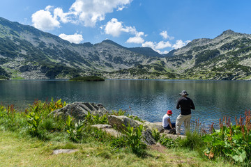 Familly enjoying on the amazing scenery towards the Popovo lake and the peaks