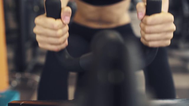 Woman working out on a exercise machine at the gym