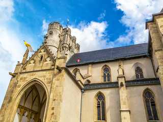 Obraz premium Exterior partial view of the old beautiful Muenstermaifeld Collegiate Church of St. Martin and St. Severus in Muenstermaifeld, Rhineland-Palatinate, Germany