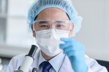 Fototapeta premium Asian man scientist researching and learning in a laboratory.