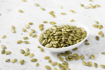 Pumpkin seeds in a white bowl