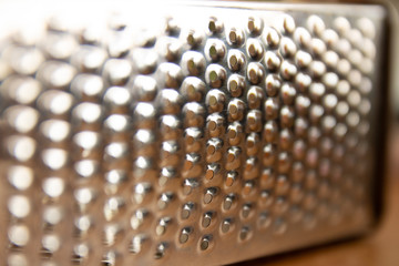 surface of kitchen metal grater, close-up view