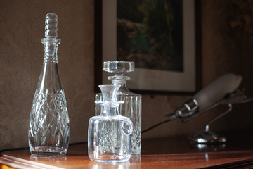Fototapeta na wymiar Three vintage glass bottles at wooden surface. Old objects. Vintage design interior.