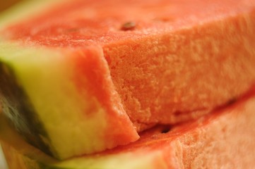 Slices of sugar watermelon lying on top of each other, closeup.