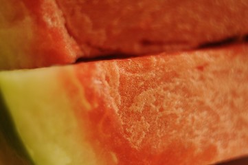 Slices of sugar watermelon lying on top of each other, closeup.