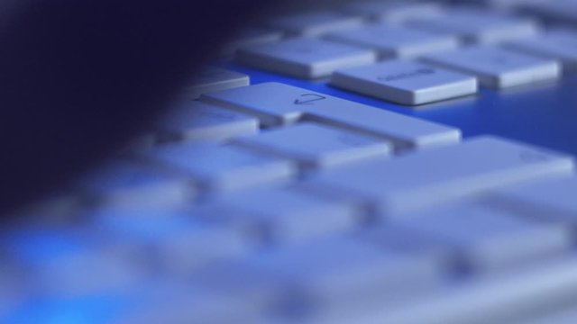 Macro Shot of Fingers Pressin Delete Backspace and Enter Keys in Monitor Light. Editing Text or Message