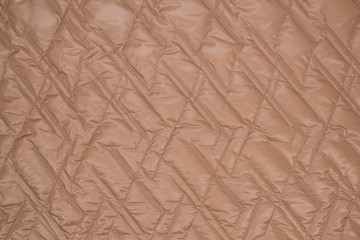 Fabric quilted lilac. The texture of the quilted jackets.