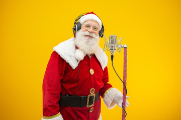 Santa Claus singing or speaking in a studio microphone. Merry Christmas. Broadcaster. Announcer....
