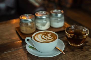 Latte coffee cup And a cup of hot tea with garnish