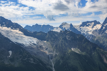 Panorama of mountains scene with dramatic blue sky in national park of Dombay