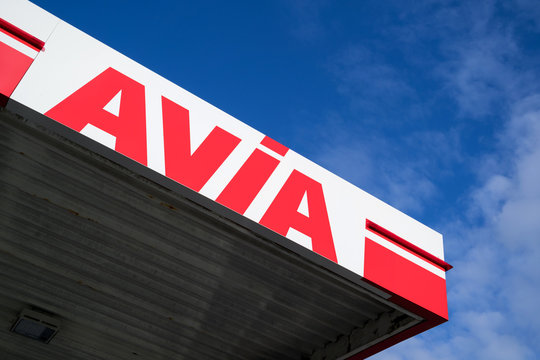 RIJNSBURG, THE NETHERLANDS - JULY 7, 2019: Avia sign at gas station against blue sky. With around 3,000 filling stations Avia is the most widely used group-independent mineral oil brand in Europe.