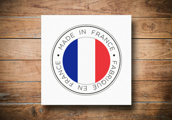 Made in France flag icon on a wooden background.