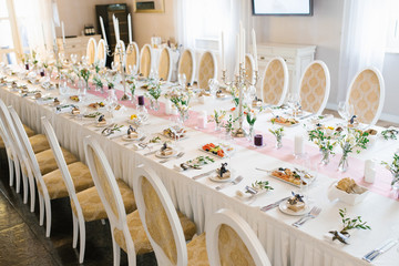 Banquet wedding table in a restaurant or cafe in beige and brown colors. Serving