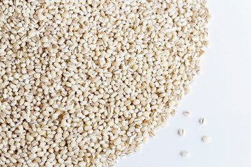 A pile of pearl barley isolated on white background with copy space for text. Concept food edible seeds for healthy. Pearl barley grains dried vegetarian food ingredient.