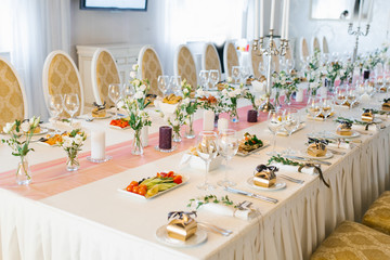 Banquet wedding table in a restaurant or cafe in beige and brown colors. Serving