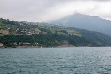 Fototapeta na wymiar View on lake Thun and mountains from ship in city Spiez, Switzerland
