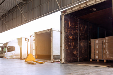 Cargo Container Trucks Parked Loading Dock at Distribution Warehouse. Shipping Trucks. Lorry. Cargo Freight Trucks Transport Logistics. - obrazy, fototapety, plakaty