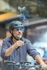 Portrait of a cyclist smoking cigarette