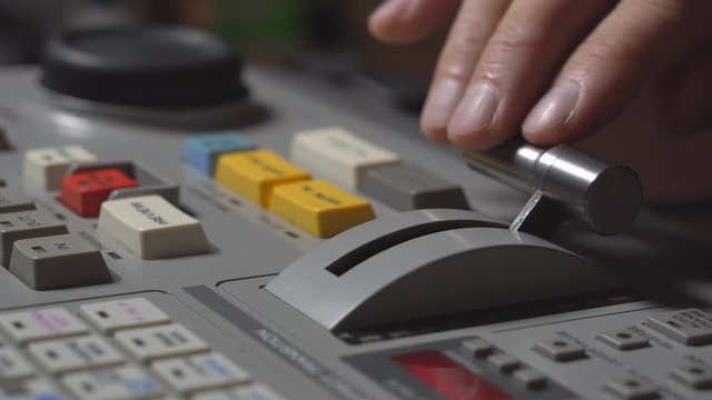 Broadcast Tv Studio Production - Vision Switcher Studio Director broadcast video mixer operation - Close-up of hand