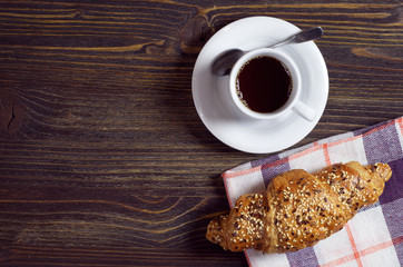Coffee and croissant on table