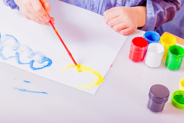 Learning Is fun! Children's art: happy cute little girl enjoying his painting.