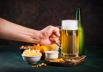Mug of beer on dark background