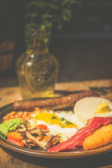 Good Ol' English Fry up Garlic and herb beef sausage with baked beans, beef bacon, cherry tomatoes, eggs, hash brown, mushy peas, mushrooms and toast